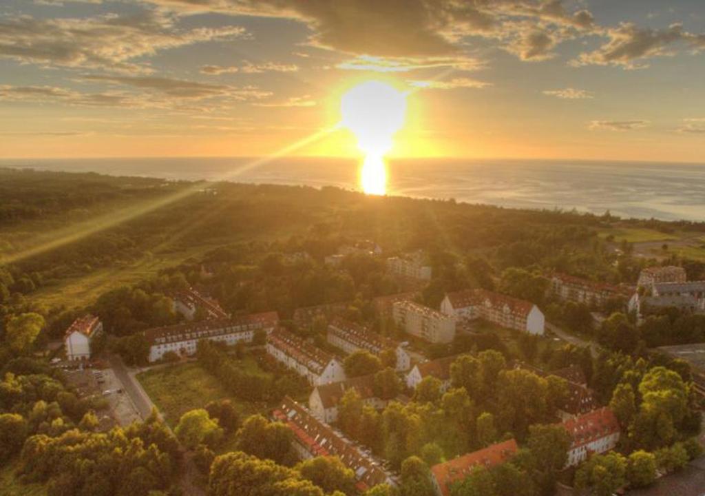 an aerial view of a city with the sun setting at Apartament blisko morza Kołobrzeg-Podczele in Kołobrzeg