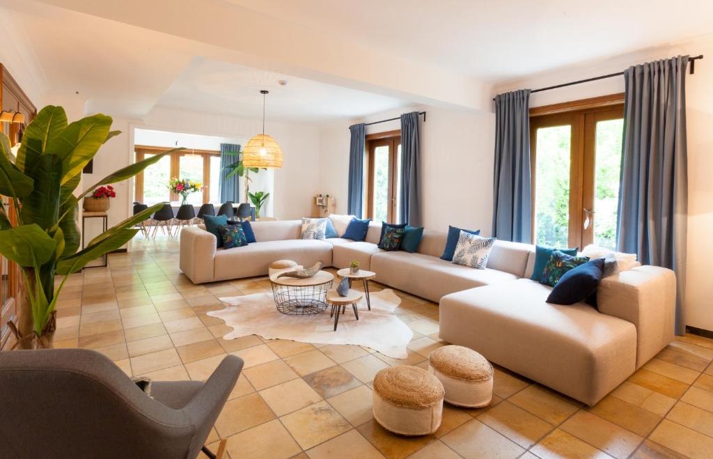 a living room with couches and a table at Vakantiehuis Elisa in Alken