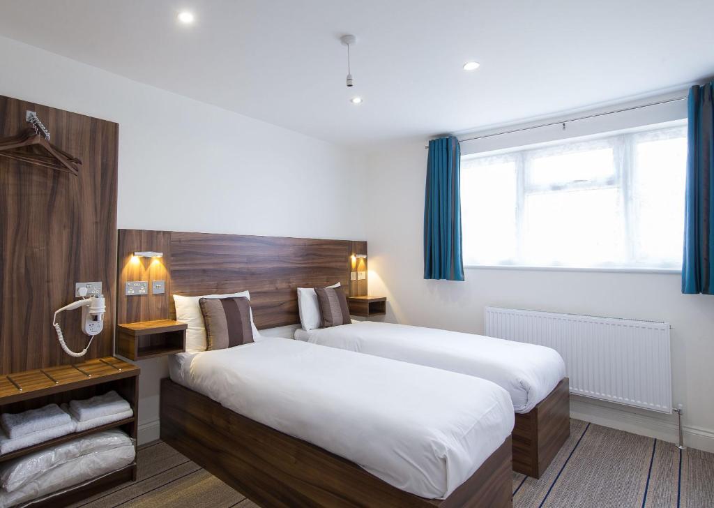 Säng eller sängar i ett rum på Heathrow-Windsor Guest House