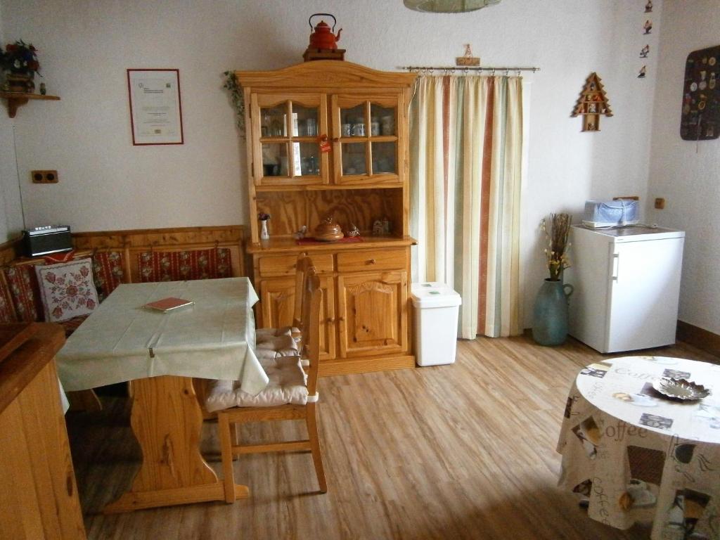 a kitchen with a table and a refrigerator at Ferienwohnung Central in Bad Steben