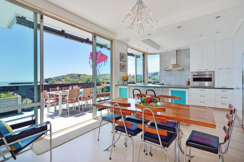 a kitchen and dining room with a table and chairs at Aporo Nelson Holiday Home in Nelson