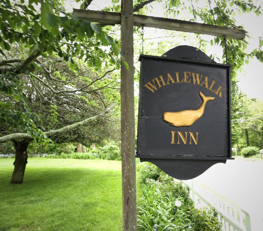 a sign for a walkway in a park at The Whalewalk Inn & Spa in Eastham