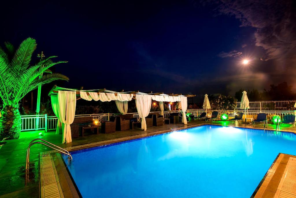 a large swimming pool at night at Hotel Diamond in Limenaria