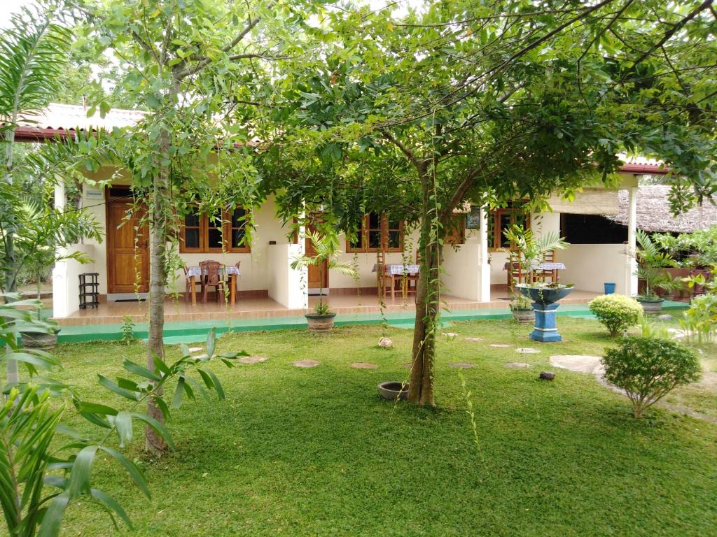 a garden view of a house with a pool at Udesh Guest in Polonnaruwa