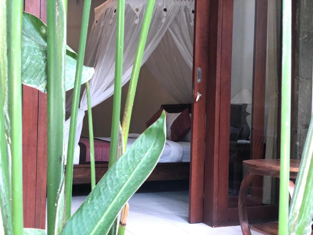 Postel nebo postele na pokoji v ubytování Umah Belos