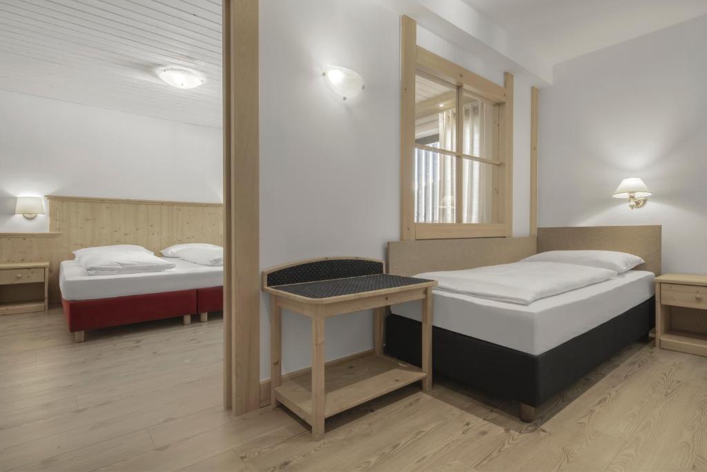 Łóżko lub łóżka w pokoju w obiekcie Hotel Krondlhof