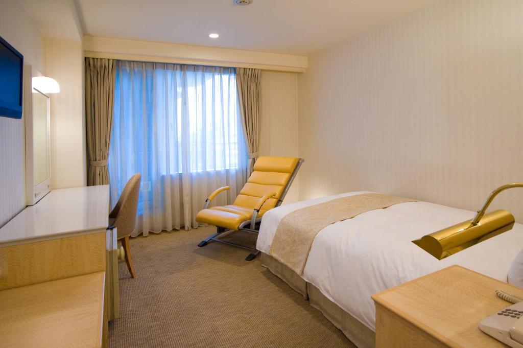 Postel nebo postele na pokoji v ubytování Hotel Yokohama Camelot Japan