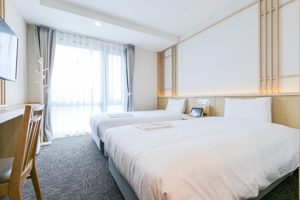 Postel nebo postele na pokoji v ubytování Henn na Hotel Premier Kyoto Eki Hachijoguchimae