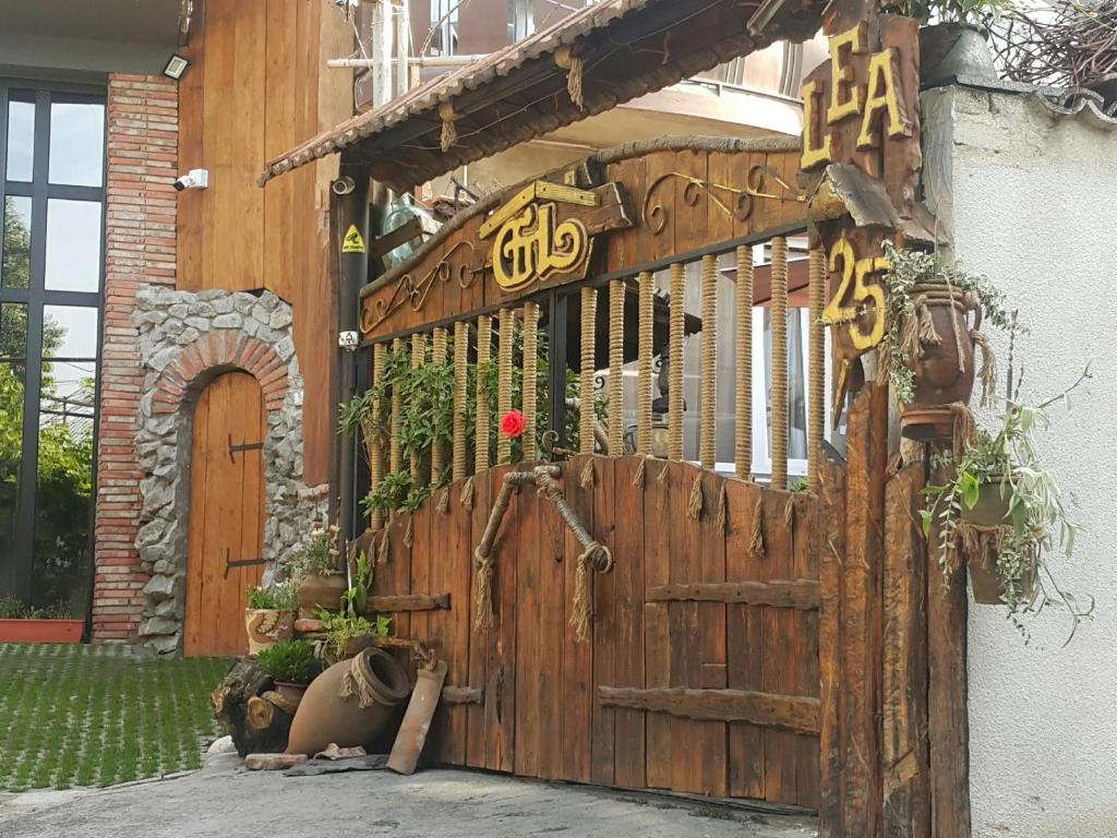 una puerta de madera con escritura china. en Lea Guest House, en Tiflis