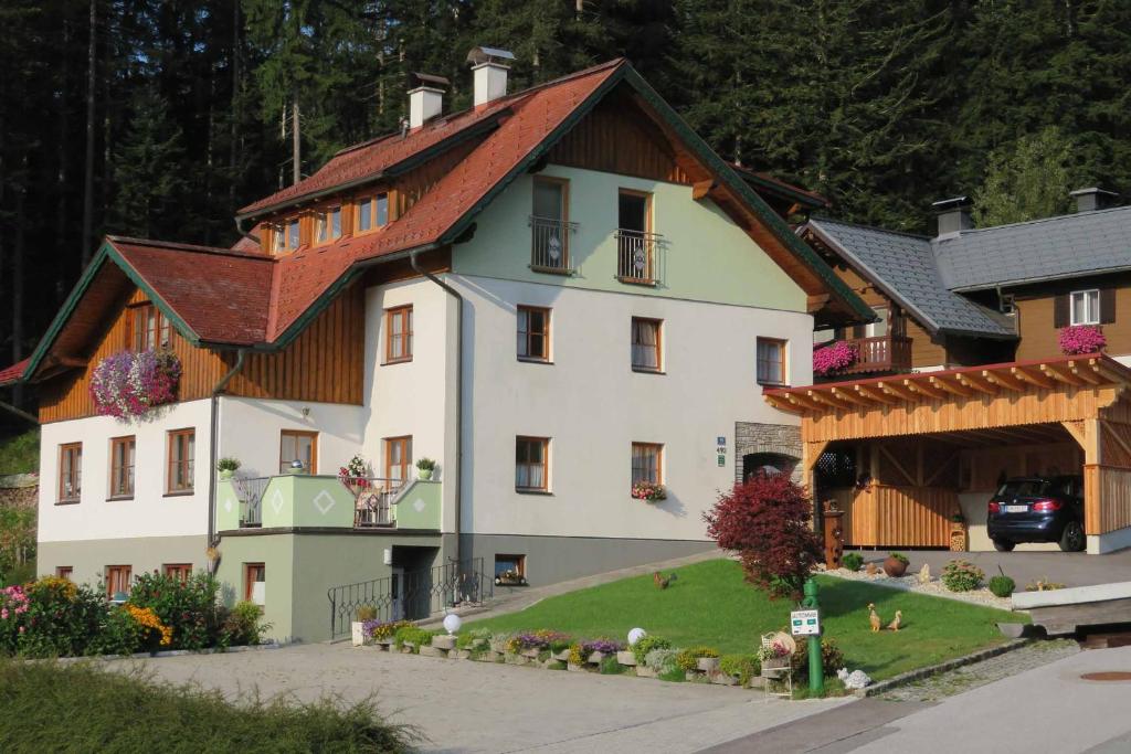 a large white building with a red roof at Apartments Egger Barbara in Gosau