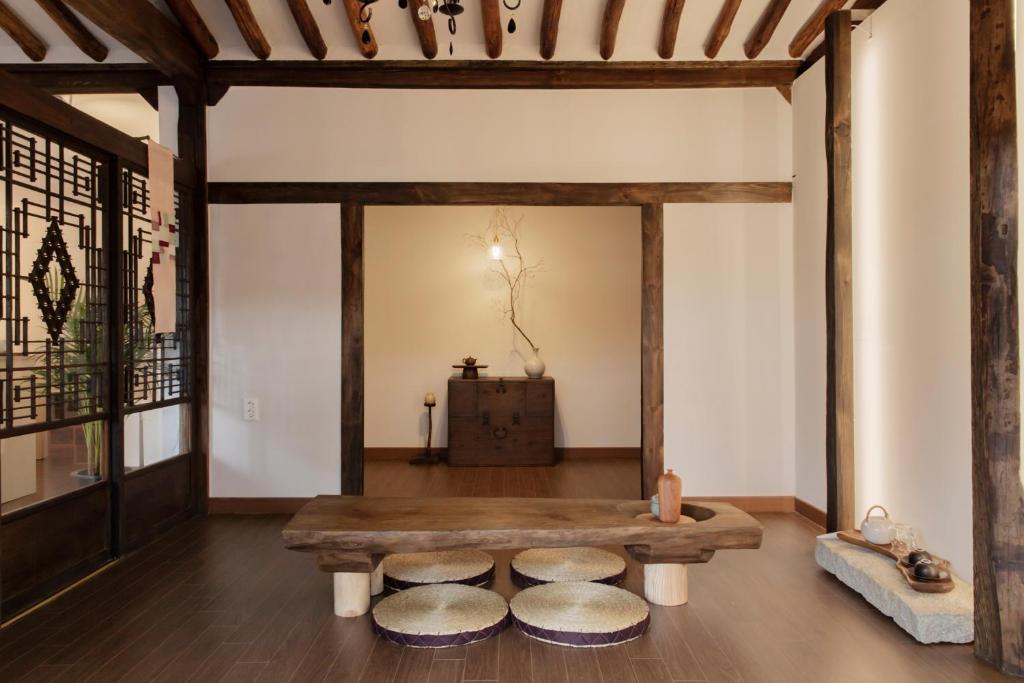 a living room with a bench and a table at Hyuhyudang in Gyeongju