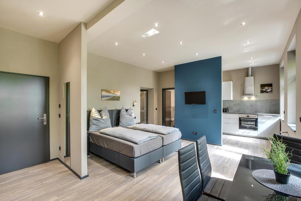 a bedroom with a bed and a living room at Liro Stadt Apartments in Krefeld