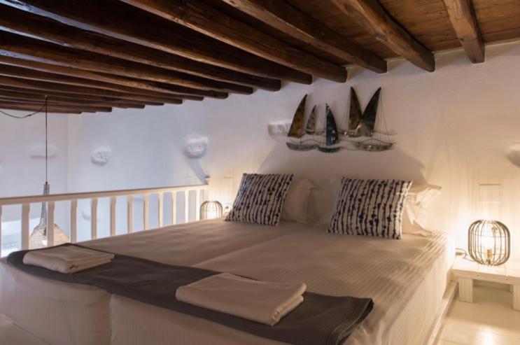 a bedroom with a large bed with sails on the wall at Apollonion house in Apollonia