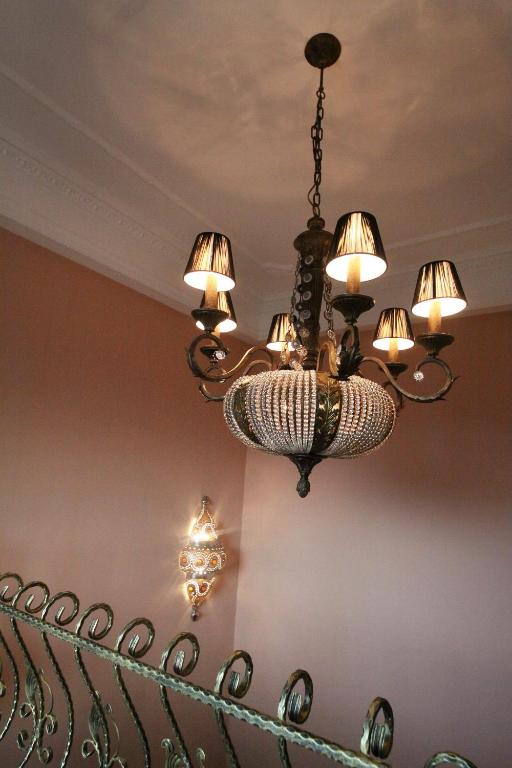 a chandelier hanging from a ceiling in a room at Sharjah B&amp;B in Wujie
