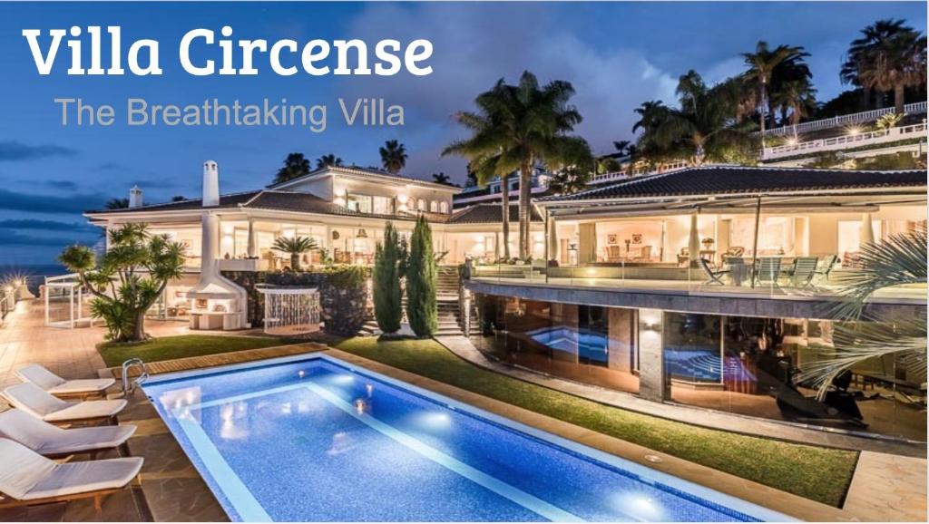 a house with a swimming pool and a villactrines the entertaining villa at Villa Circense in Santa Úrsula
