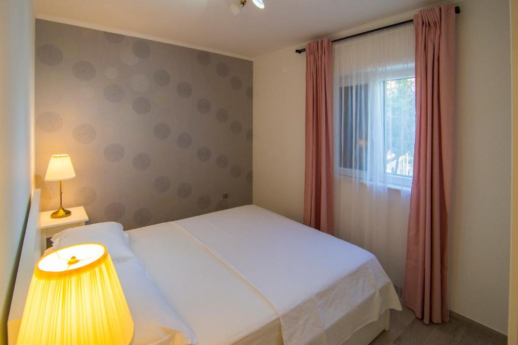 Postel nebo postele na pokoji v ubytování Apartments Pina