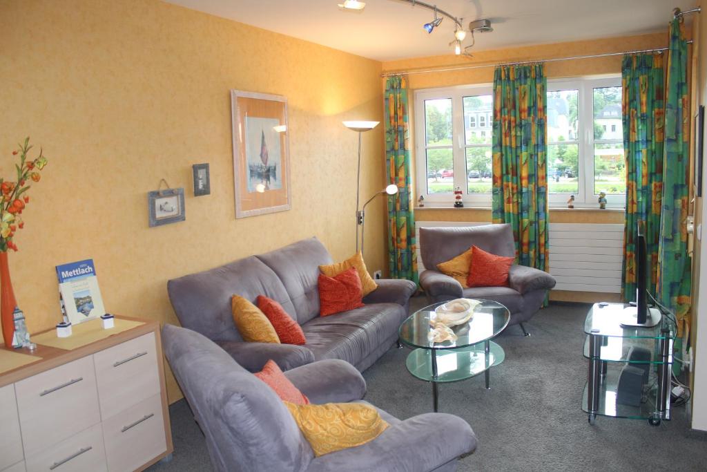 a living room with two couches and a table at Fährhaus Ferienwohnung in Saarburg