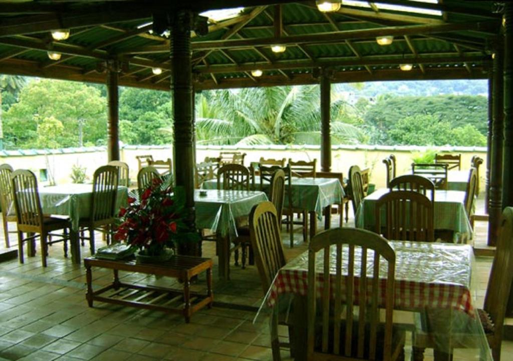 A restaurant or other place to eat at Palm Garden Home Stay