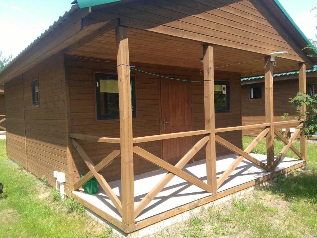 a large wooden cabin with a large door at domki pestka in Jastrzębia Góra