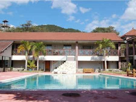a large swimming pool in front of a building at Amami Resort Bashayamamura in Amami