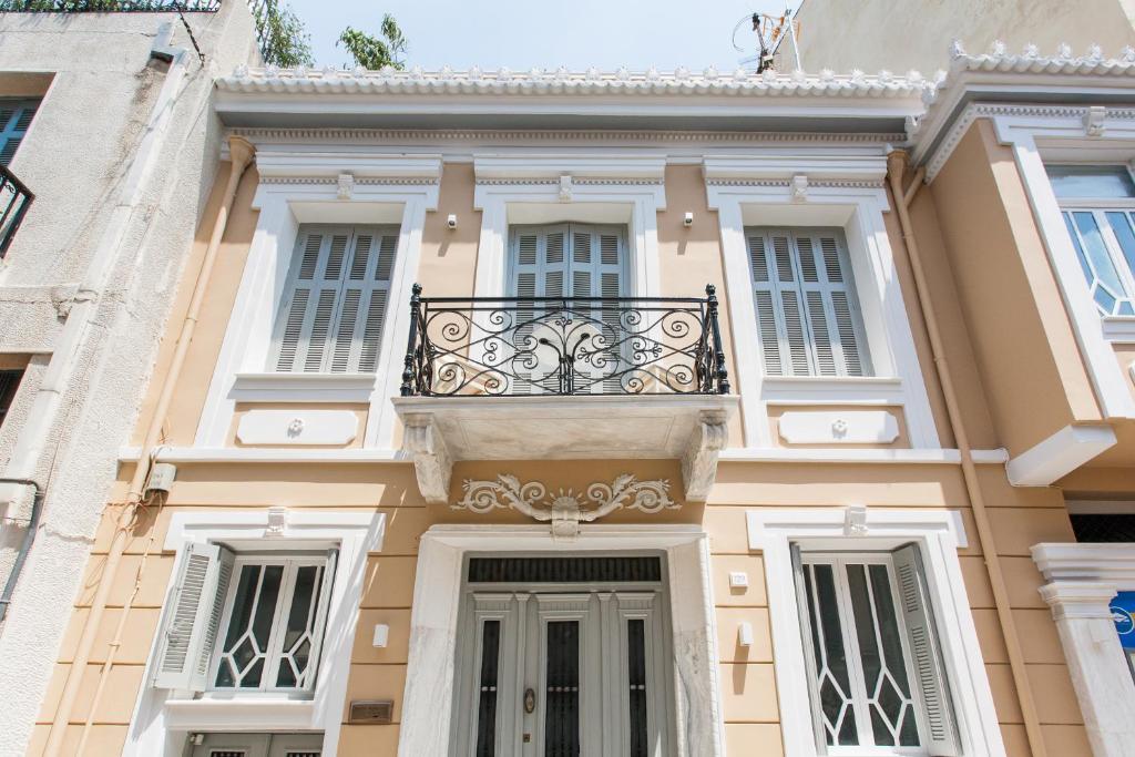 a large white building with a clock on the front of it at Step One | Luxury Suites right in the heart of Acropolis next to metro station in Athens