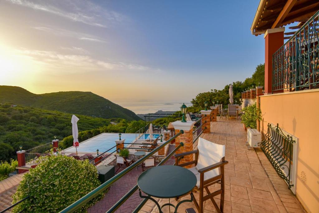 a balcony with a view of a pool and mountains at Corfu Sokraki Villas in Sokrakion