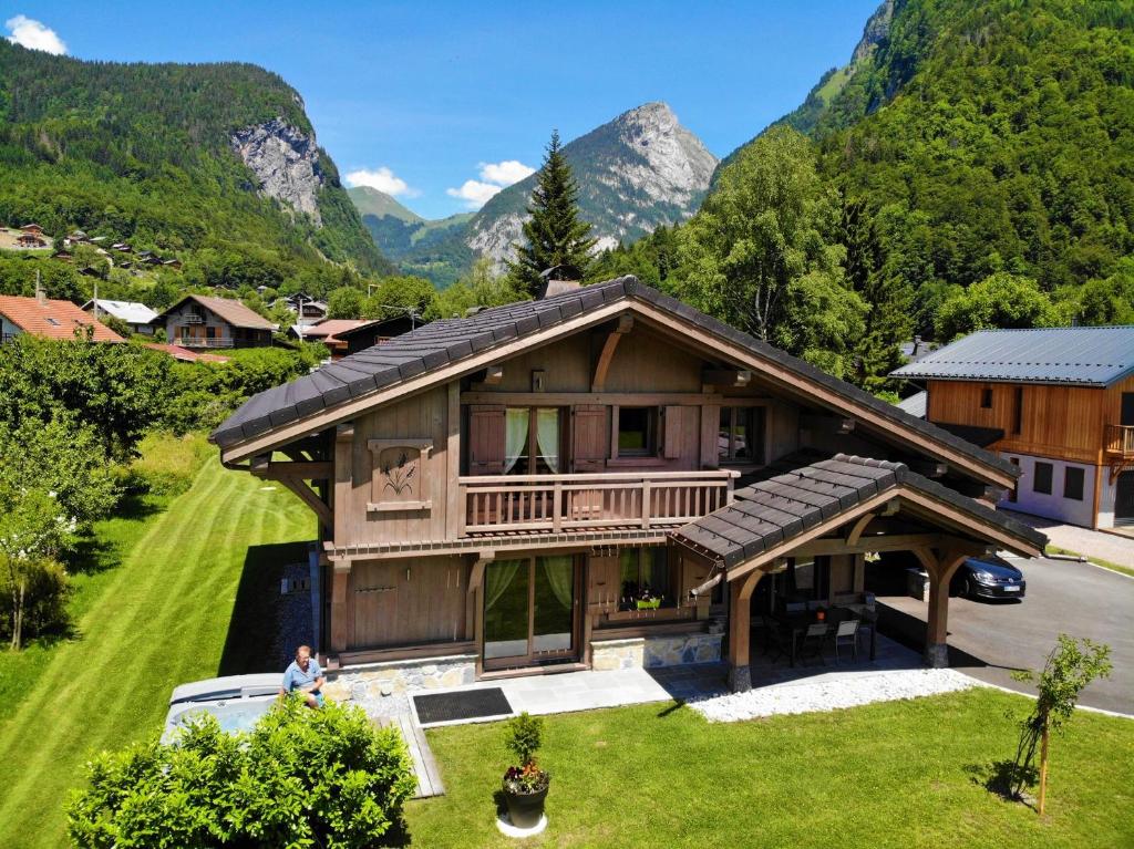 an aerial view of a house with mountains in the background at Chalet Luxe Les Mélèzes in Samoëns