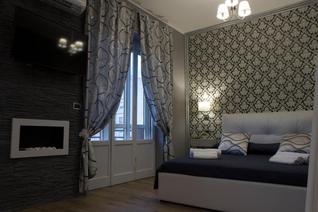 Postel nebo postele na pokoji v ubytování Home Syrakos B&B