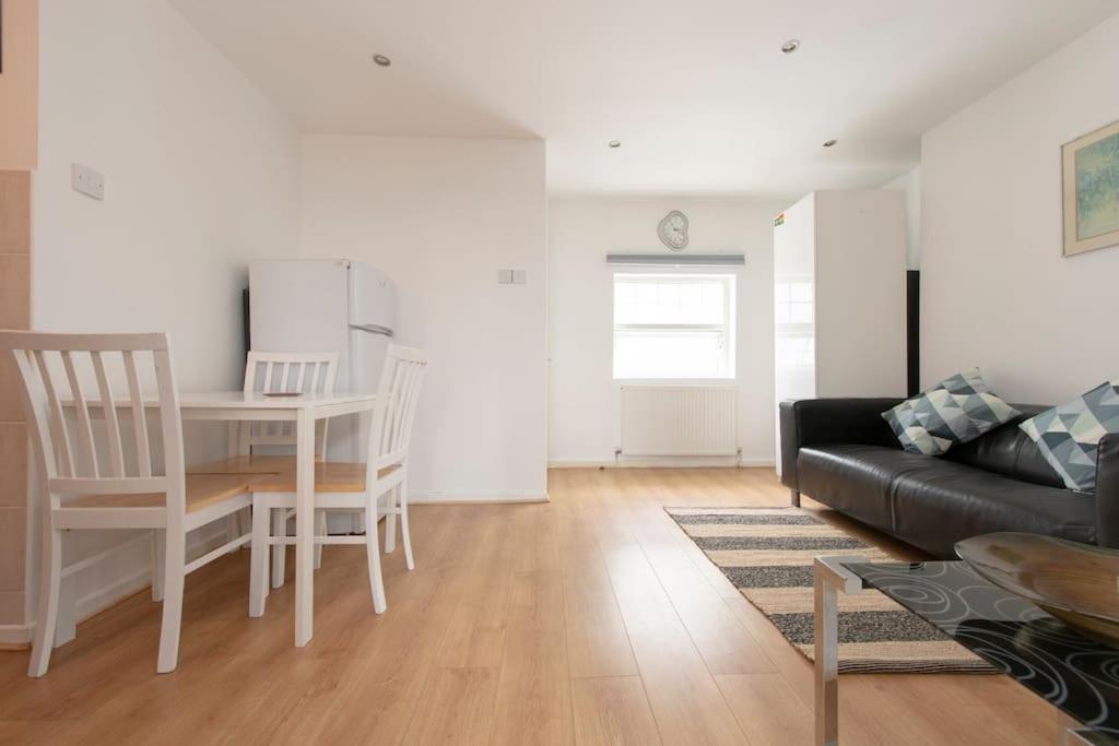 a living room with a table and a couch at The CoDalston in London