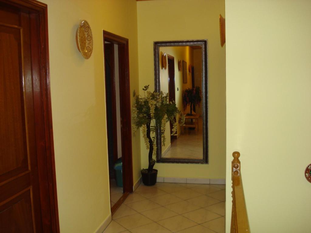 a hallway with a mirror on the wall and a floor at Royal Villa in Balatonfüred