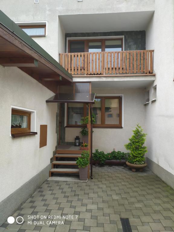 a house with a staircase and a balcony at Apartmán Jarka in Bodice