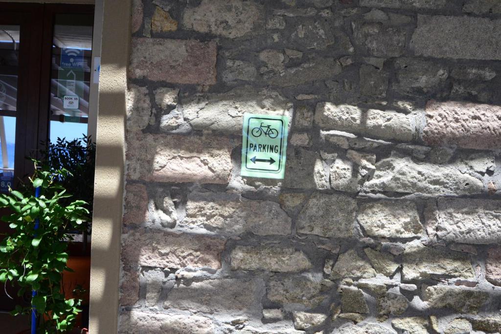 a stone wall with a bike sign on it at Sappho Hotel in Skala Eresou