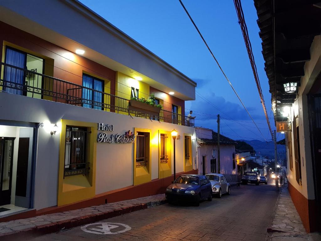 a street with cars parked on the side of a building at Hotel Real Colonial in Comitán
