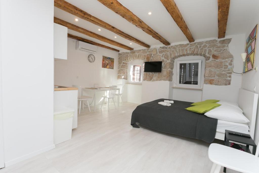 a bedroom with a bed and a kitchen in a room at Apartment Relax in Rijeka