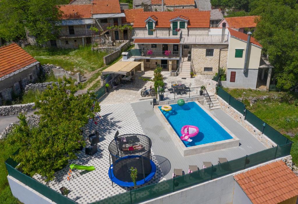 an aerial view of a backyard with a swimming pool at Holiday home Stipanovi Dvori with jacuzzi and pool in Zagvozd