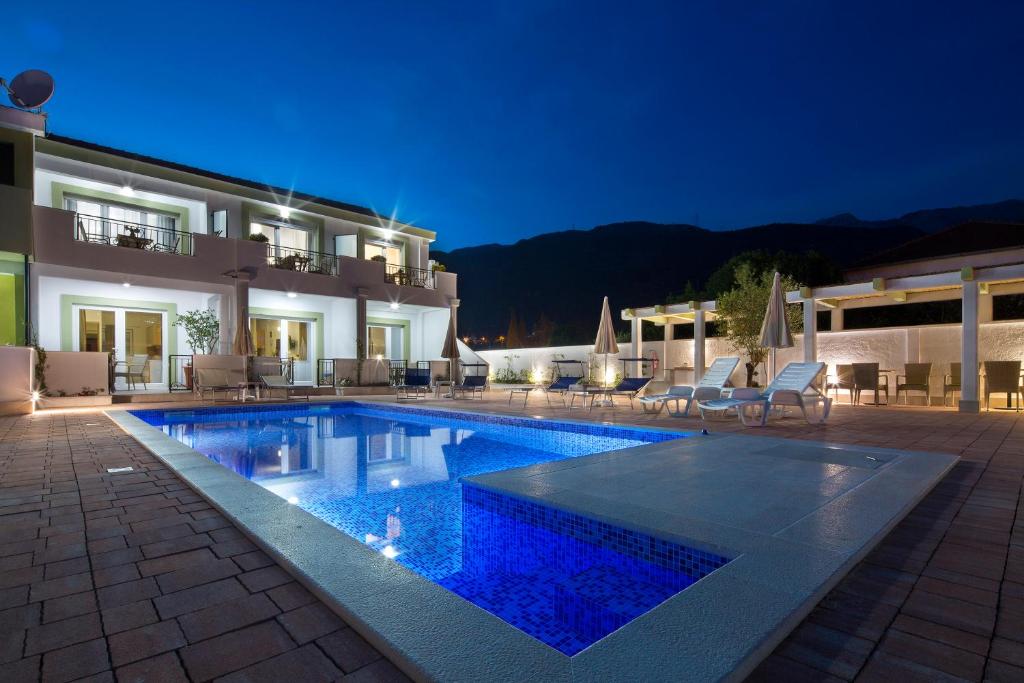 a villa with a swimming pool at night at Luxurious Apartments Aria in Budva