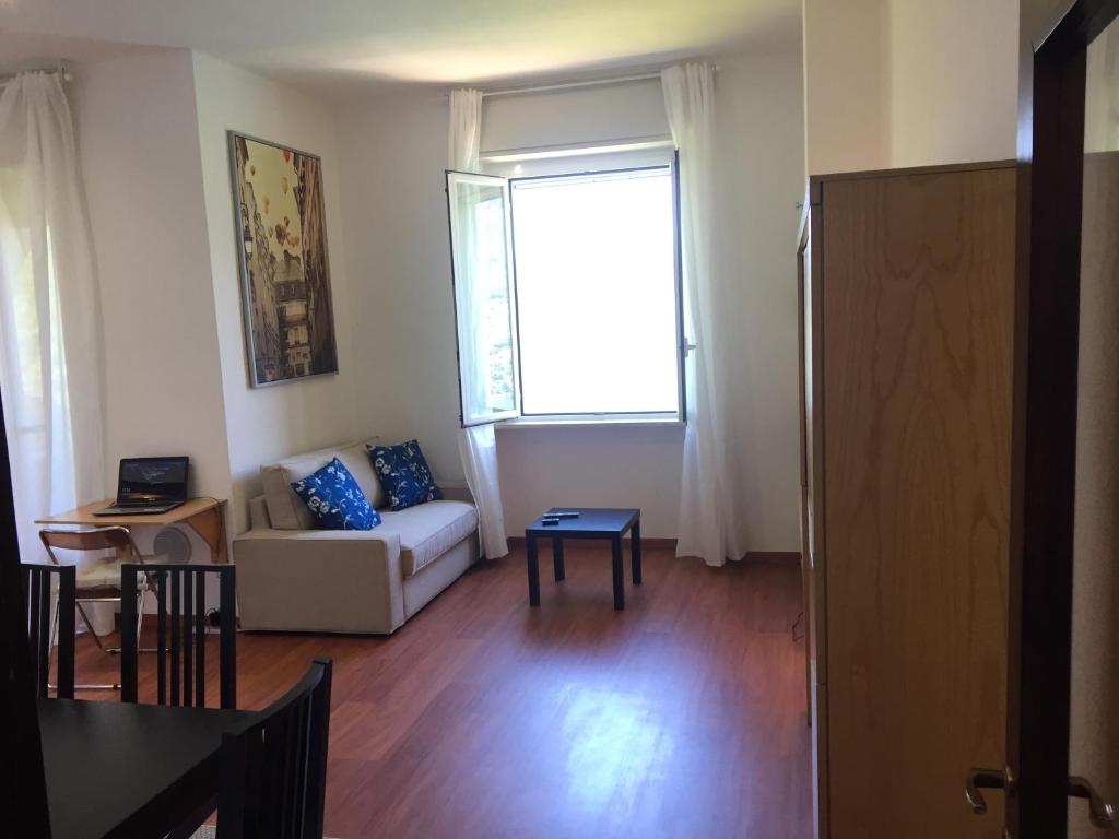 a living room with a couch and a window at Bellagio Dream in Valbrona