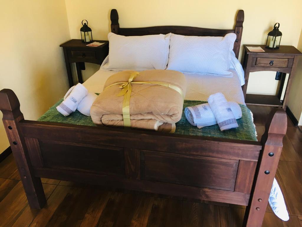 a bed with two pillows and towels on it at Hospedaje “ El Segoviano “ in Carmelo