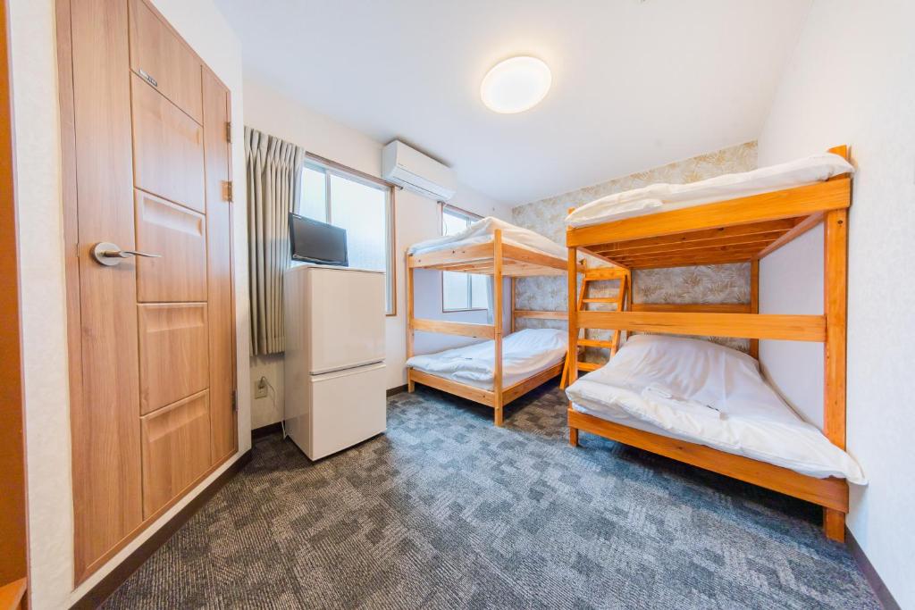 Postel nebo postele na pokoji v ubytování Tokyo SA Ryokan