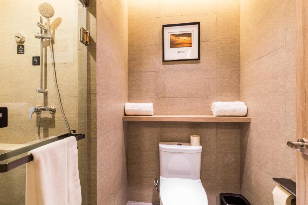 a small bathroom with a toilet and a shower at Atour Hotel Changxing Central Plaza in Changxing