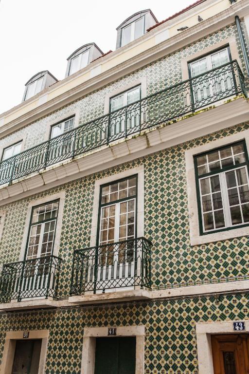 a green and white building with windows and balconies at Rossio Convento da Encarnação in Lisbon
