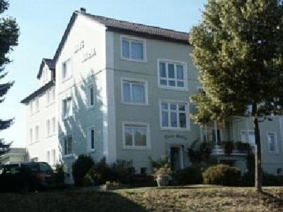 a white building with a tree in front of it at Haus-Maria in Bad Salzschlirf