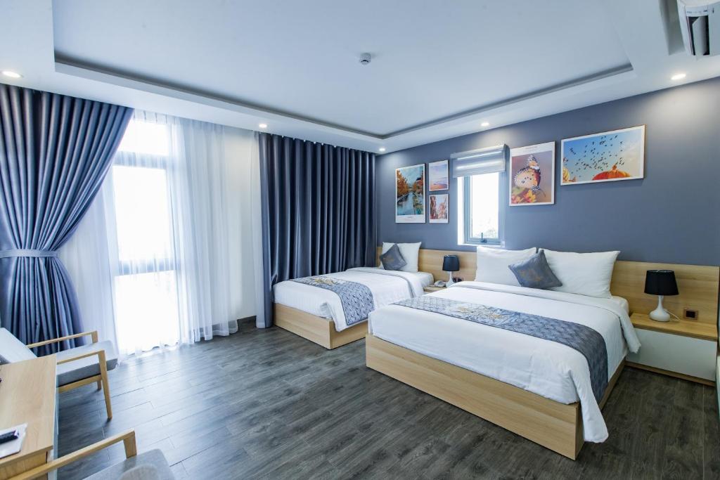 Postel nebo postele na pokoji v ubytování Dang's Hotel