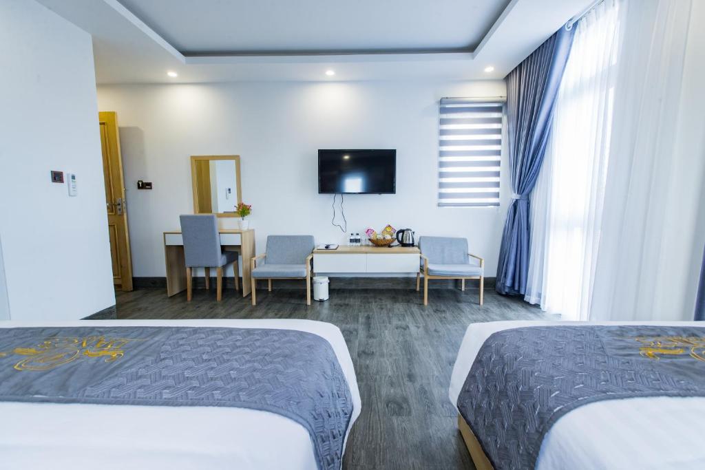 Postel nebo postele na pokoji v ubytování Dang's Hotel