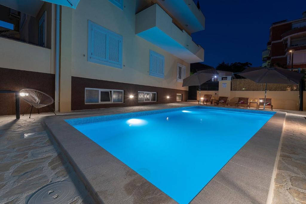 a swimming pool in the middle of a building at night at Apartments Dijana in Zadar