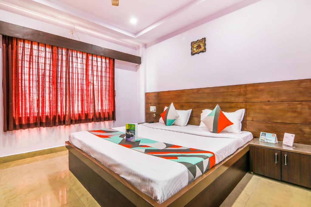a bedroom with a large bed and a window at Yashaswi Comforts in Mysore
