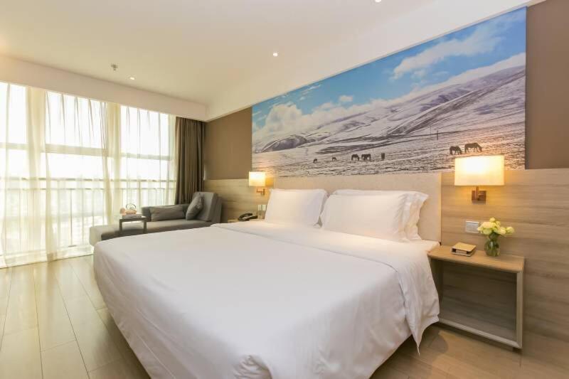 a large white bed in a hotel room at Atour Hotel Chengdu New Convention and Exhibition Center Branch in Chengdu