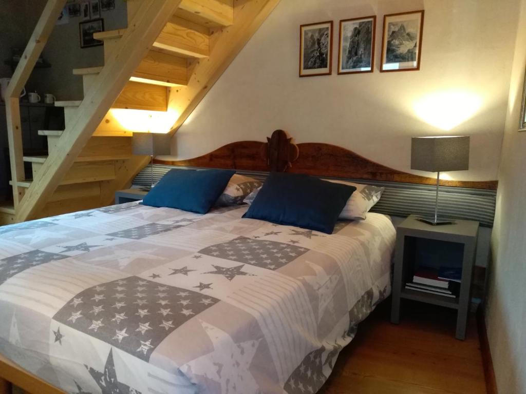 a bedroom with a large bed with blue pillows at Telemark Mountain Rooms in Agordo