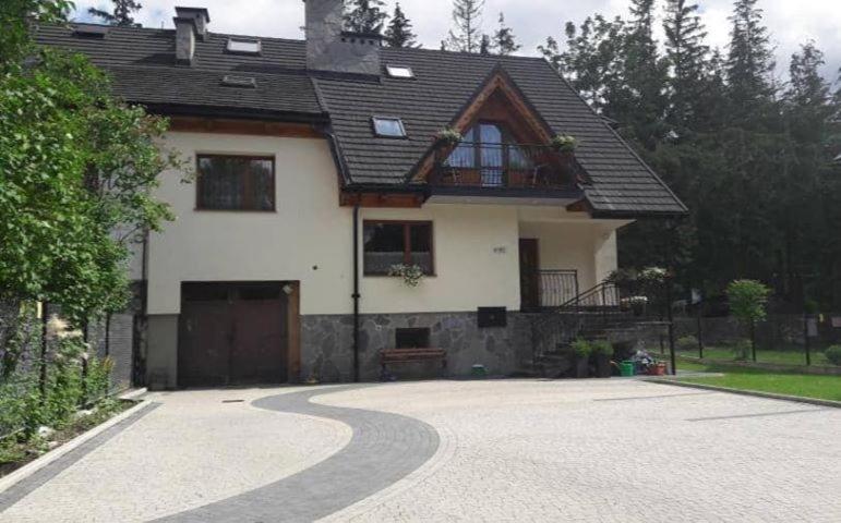 a house with a driveway in front of it at Willa Małgorzata pod skocznią in Zakopane