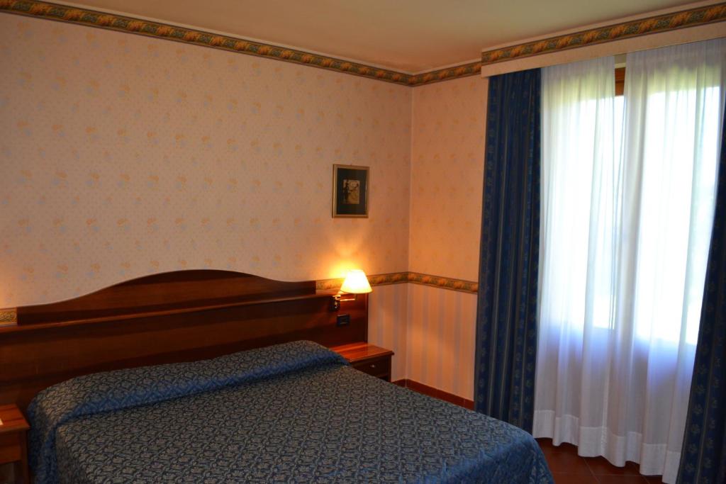 Postel nebo postele na pokoji v ubytování Ariotto Village